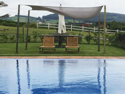 a table and two chairs next to a swimming pool at La Lagartija Adults Only in Ajo