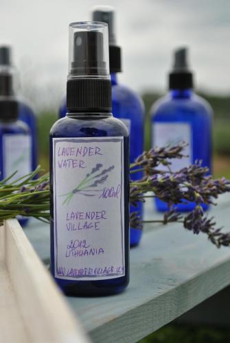 a bottle of lavender water sitting on a table at Lavender Village in Kiemeliai