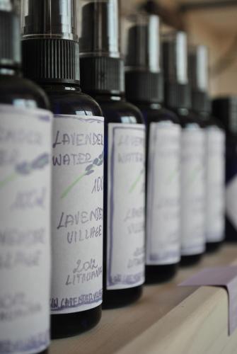 a row of bottles of liquids sitting on a table at Lavender Village in Kiemeliai