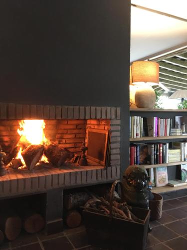 a brick fireplace with a fire in it at La Lagartija Adults Only in Ajo