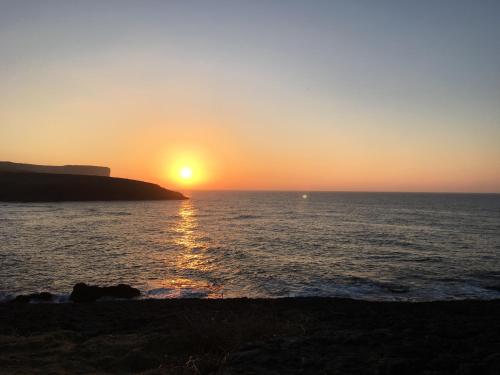 a sunset over the ocean with the sun setting at La Lagartija Adults Only in Ajo