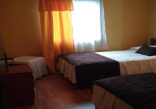 
A bed or beds in a room at Hostal Beraca
