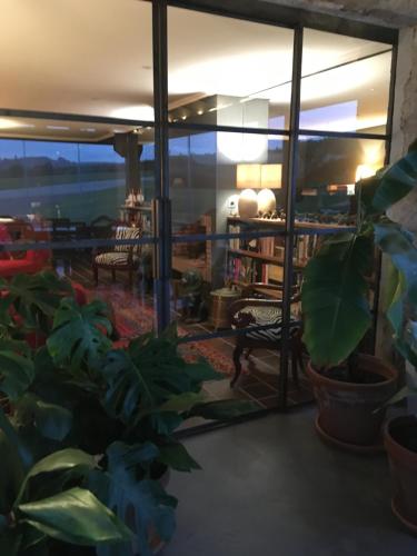 a living room with a large window and plants at La Lagartija Adults Only in Ajo