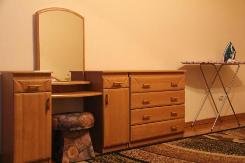 a dressing room with a wooden dresser and a mirror at Apartments Domovik ,Kirilla i Mefodiya, 5 in Mukacheve