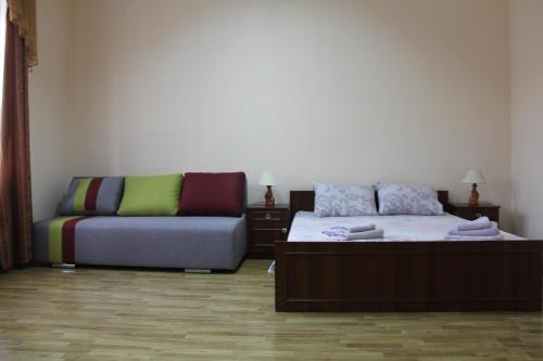 a living room with a bed and a couch at Apartments Domovik ,Kirilla i Mefodiya, 5 in Mukacheve