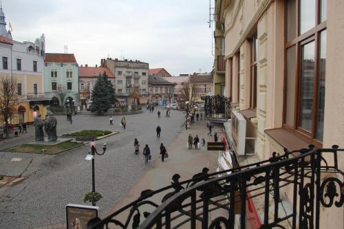 a group of people walking down a city street at Apartments Domovik ,Kirilla i Mefodiya, 5 in Mukacheve