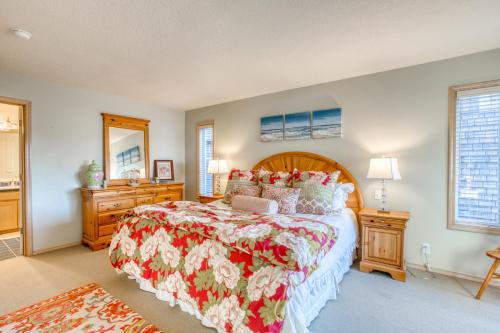 a bedroom with a large bed with a red and white blanket at Chapman Point Cannon Beach Home with hot-tub in Cannon Beach