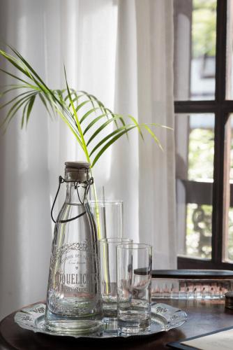 a glass jug and two glasses on a table at Villa Balthazar in Búzios