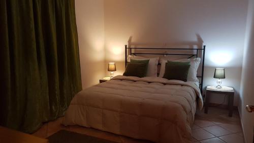 a bedroom with a large bed with two lamps at Villa Isotta in Trevignano Romano