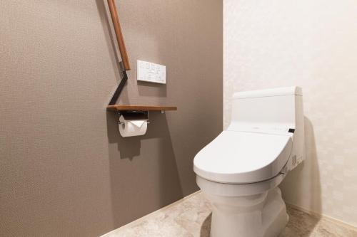 a bathroom with a white toilet in a stall at GRAND BASE Nagasaki Ekimae in Nagasaki
