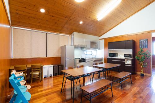 a kitchen with tables and chairs in a room at HOLIDAY INN GARAKUTA in Ishigaki Island