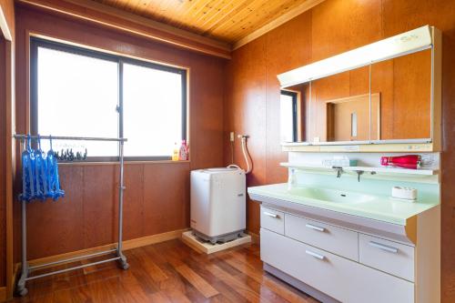 Un baño con lavabo y ventana. en HOLIDAY INN GARAKUTA, en Ishigaki Island