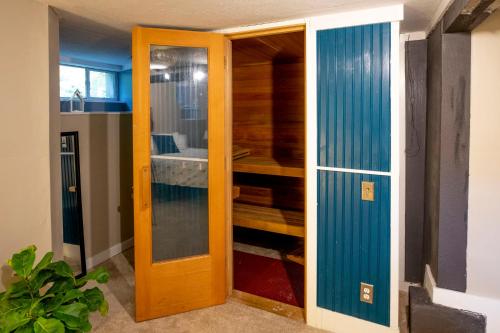 a closet with a wooden door in a room at 3BD HOME Downtown SLC - Hot Tub - SAUNA-fast wifi in Salt Lake City