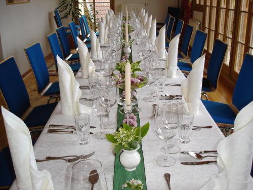 a long table with wine glasses and flowers on it at Alte Post in Feistritz an der Gail
