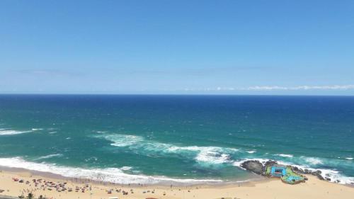 an aerial view of a beach and the ocean at High Tide in Amanzimtoti