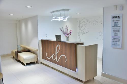 a lobby with a reception desk and a chair at Casa Lua Hotel Spa in Chía
