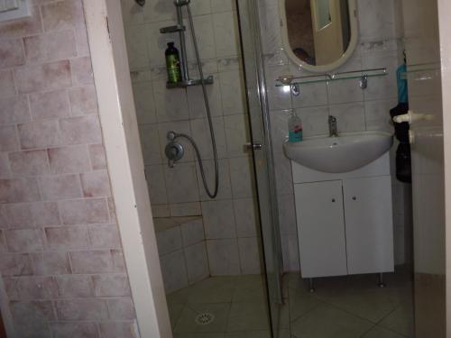 uma casa de banho com um chuveiro e um lavatório. em Zimmer Arad Dead Sea, Big and Confortabוl Apartment, logic cost - במחיר שפוי em Arad
