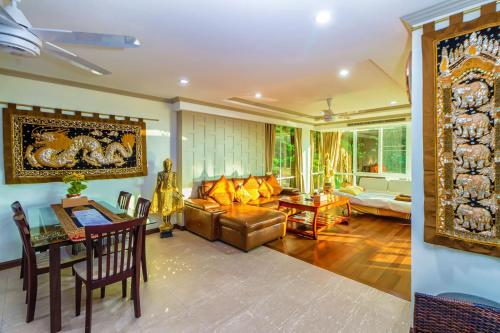 a living room with a couch and a table at Karon View Apartments in Karon Beach