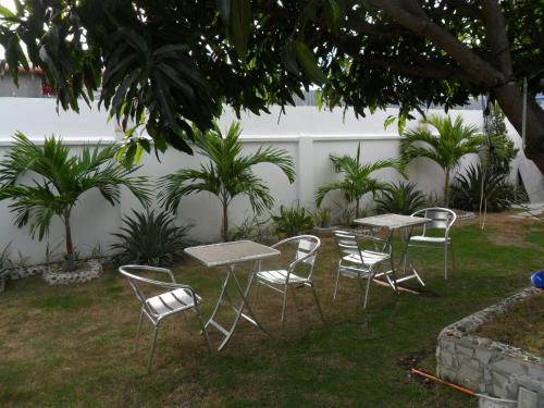 eine Gruppe von Tischen und Stühlen in einem Hof in der Unterkunft Jasmin's Room Rental, Room # 3 in Moalboal