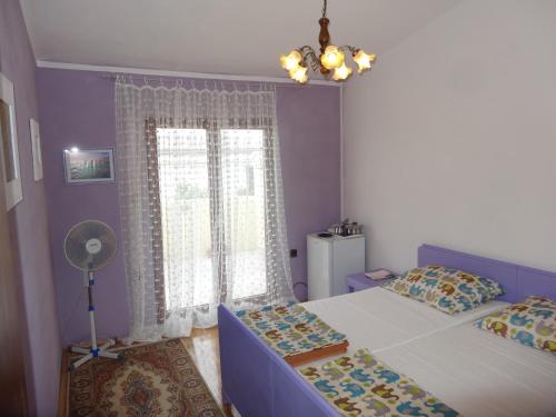 a bedroom with two beds and a window at Romantic room Vir in Vir
