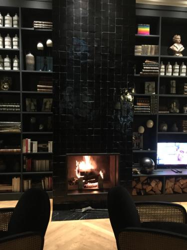 a fireplace in a living room with a fire place at Hotel Victoria in Valence