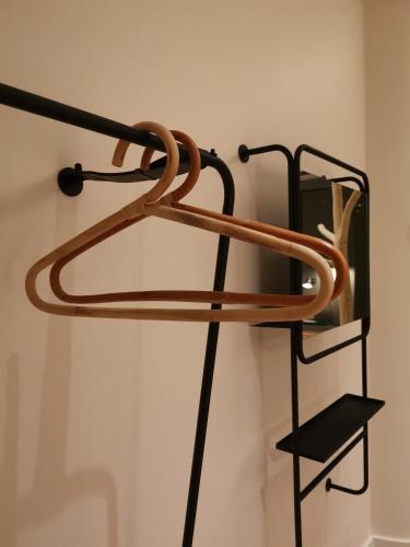 a wooden rack with a shelf on a wall at Three House Hotel in Funchal