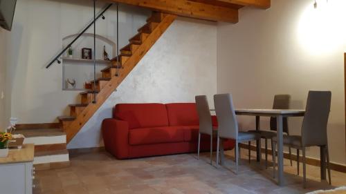 a living room with a red couch and a table at La casetta nel claustro in Altamura