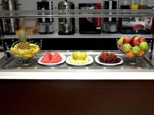 a bunch of bowls of fruit on a counter at Breeze Boutique Athens by Prima Hotels in Athens