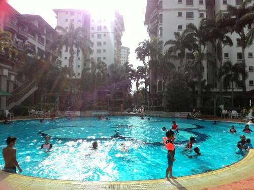 a group of people in a swimming pool in a city at Costa Mahkota (Family Homestay) @ Mahkota Melaka in Melaka