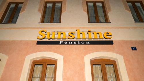 a sign on the side of a building at Sunshine Pension in Karlovy Vary