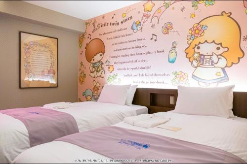 two beds in a room with a wall with a mural at HOTEL OKINAWA WITH SANRIO CHARACTERS in Naha