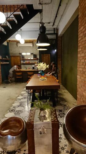a room with a table with flowers on it at Mr. Buster B&B in Hualien City