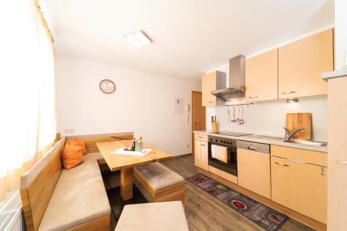 a kitchen with a table and a dining room at Ferienhaus Gundi in Pettneu am Arlberg