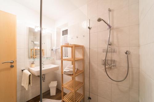 a bathroom with a shower and a sink at Ferienhaus Gundi in Pettneu am Arlberg