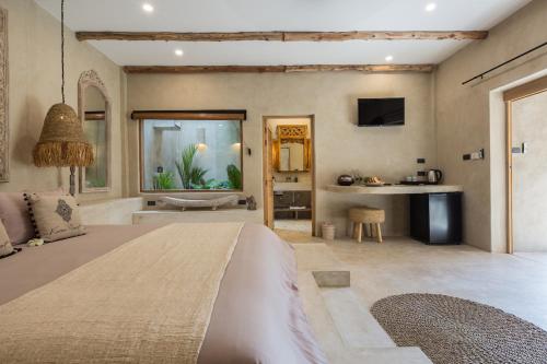 a bedroom with a large bed and a bathroom at Karma Resort in Bophut 