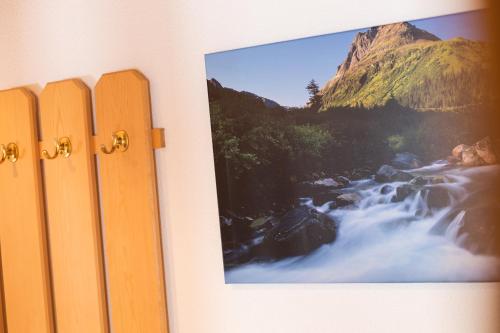 a picture of a waterfall on a wall at Ferienhaus Gundi in Pettneu am Arlberg