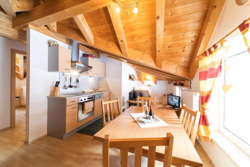 a kitchen and dining room with a wooden table and chairs at Ferienhaus Gundi in Pettneu am Arlberg