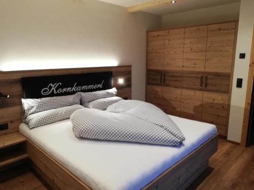 a bed with two pillows on it in a room at Gasthaus Goglhof in Fügenberg