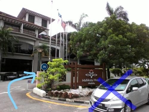 a car parked in front of a building at Costa Mahkota (Family Homestay) @ Mahkota Melaka in Melaka
