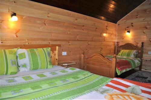 Postel nebo postele na pokoji v ubytování Stone Lodge 2