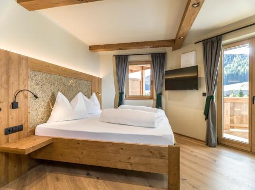 a bedroom with a large bed with white pillows at Apartments Riega in Sesto