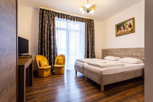 a hotel room with a bed and a window at Gold Rooms in Koszalin