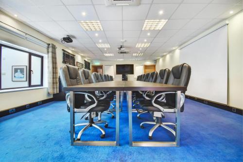 a conference room with a table and chairs at Sturmer Hall Hotel and Conference Centre in Haverhill