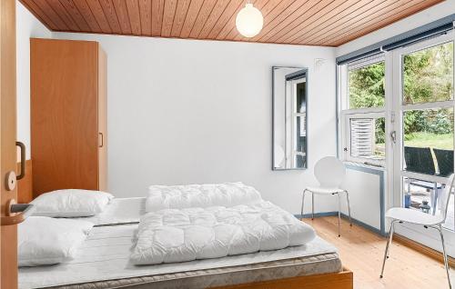 a white bedroom with a bed and a window at Awesome Home In Gedser With Sauna in Gedser