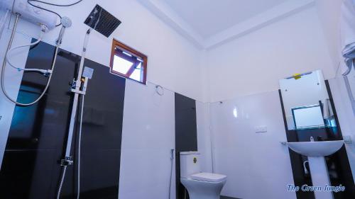 a bathroom with a toilet and a sink at The Green Jungle in Dambulla