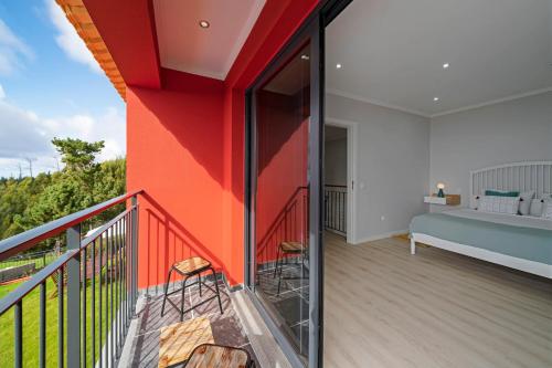 a balcony with a red and white wall at Vilas Felicidade Rocha by An Island Apart in Ponta do Pargo