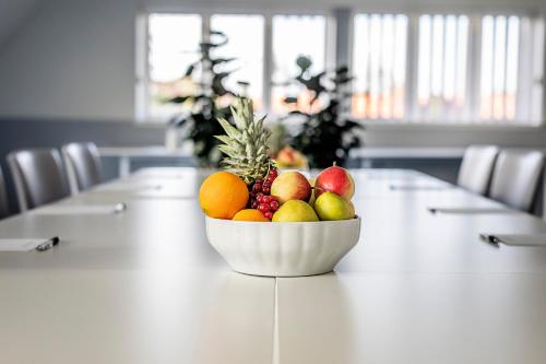 a bowl of fruit sitting on a table at Molskroen Strandhus in Ebeltoft