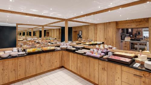 a buffet line with food on display in a restaurant at Morosani Schweizerhof in Davos