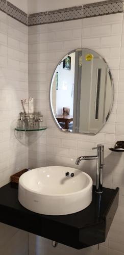 a white bathroom with a sink and a mirror at Phú Vy Bungalow Phú Quốc in Phú Quốc