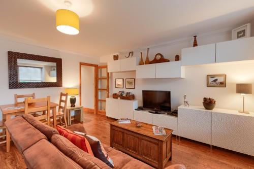 コムリーにあるDundas Flat, 1 bedroom, Comrieのソファとテーブルのあるリビングルーム